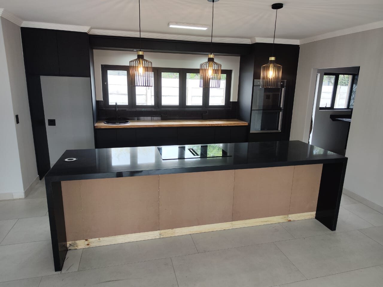 Matte black kitchen with waterfall island
