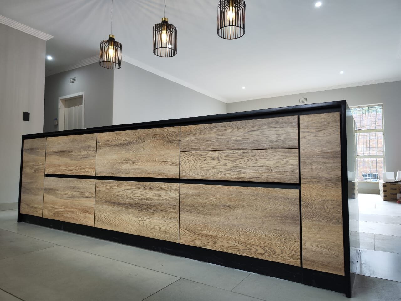 Oak kitchen island against exposed brick