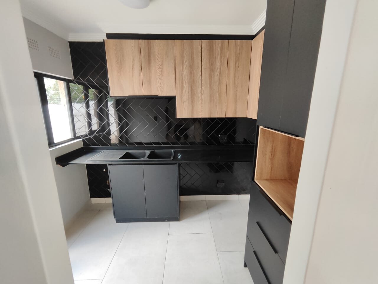 Black herringbone tile scullery